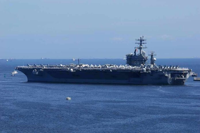 shutterstock_1340097212 Aircraft carrier at sea with crew lining the deck