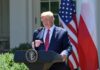 man at presidential podium speaking outdoors