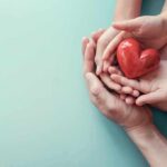 Hands holding a red heart