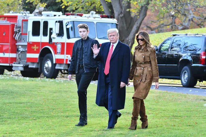 three people walking on grass near fire truck and SUV