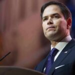 War With China? Rubio’s Chilling Warning man in suit speaking at podium