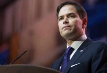 War With China? Rubio’s Chilling Warning man in suit speaking at podium