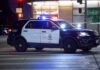 Outrage In Portland: Intruder Sues Shooter Police SUV blocks an intersection at night with lights flashing