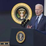 man in suit speaking at presidential podium
