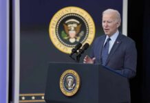 man in suit speaking at presidential podium