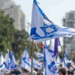 Iranian Plot to Murder Netanyahu’s Son? Israeli flags waved at a street demonstration