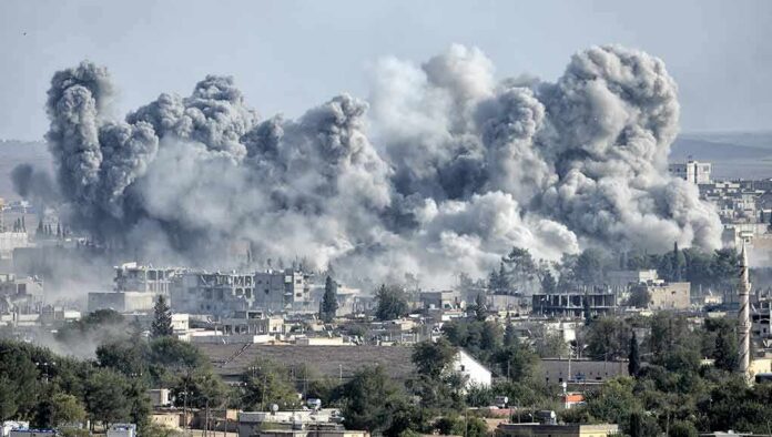 Massive smoke plumes rise over a city after explosions