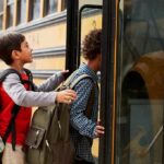 Children boarding a yellow school bus