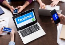 Laptop with Facebook on screen surrounded by smartphones