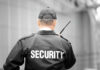 Security guard holding a walkie-talkie.