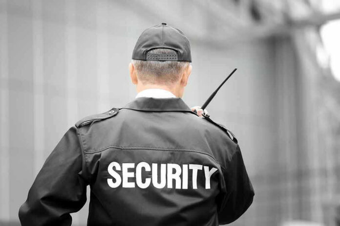 Security guard holding a walkie-talkie.