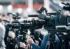 AI Cracks Whale Alphabet Broadcast cameras on tripods at a press event