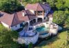 Luxury hillside stone mansion with tiered pool and spa