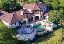 Luxury hillside stone mansion with tiered pool and spa
