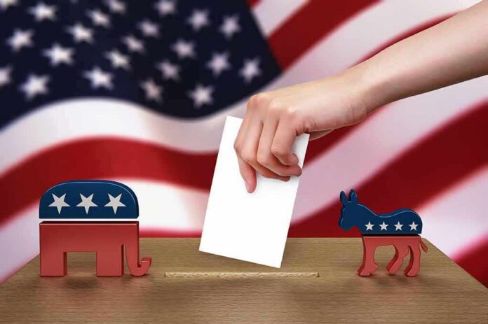 shutterstock_102884888 Hand casting ballot between Republican elephant and Democratic donkey