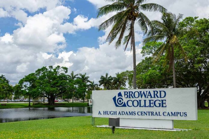 shutterstock_1120535381 Broward College campus sign by palm trees and pond