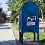 CA Mailman Arrested – You Won’t Believe Why Blue USPS mailbox on a suburban sidewalk