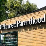 Planned Parenthood clinic exterior with sign on wooden facade