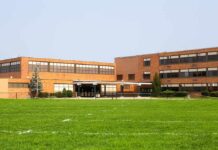 Brick school building with large windows and front entrance