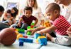Married-Only Perk Sparks Funding Brawl Karyn Polito with toddlers building blocks on a play mat