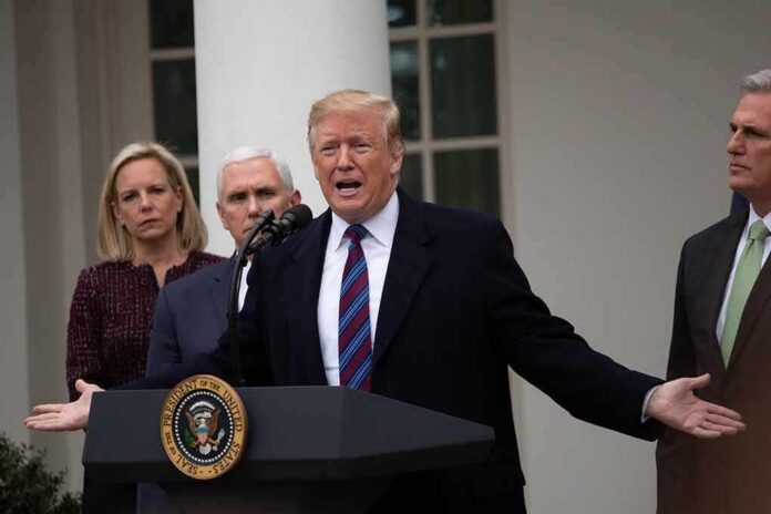 Donald Trump speaks at a podium with Mike Pence and Kevin McCarthy nearby