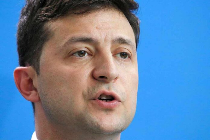 June,18,,2019,-,Berlin:,Volodymyr,Zelensky,-,Meeting,Of Volodymyr Zelensky speaking in a close-up portrait against a blue background