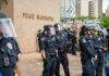 Teddy Williams and Carlos Hyde among police officers in riot gear outside police headquarters