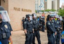 Hanging Death Twist: Marshals Join Manhunt Teddy Williams and Carlos Hyde among police officers in riot gear outside police headquarters