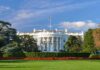 The White House with lawn and American flag