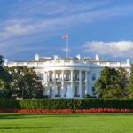 The White House with lawn and American flag