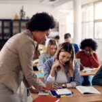 Teacher assisting student in classroom