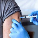 Healthcare worker giving an arm injection