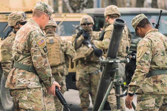 Soldiers in camouflage gather around a mortar during field training