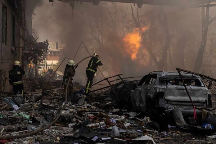 Firefighters tackle blaze amid rubble and a burned car