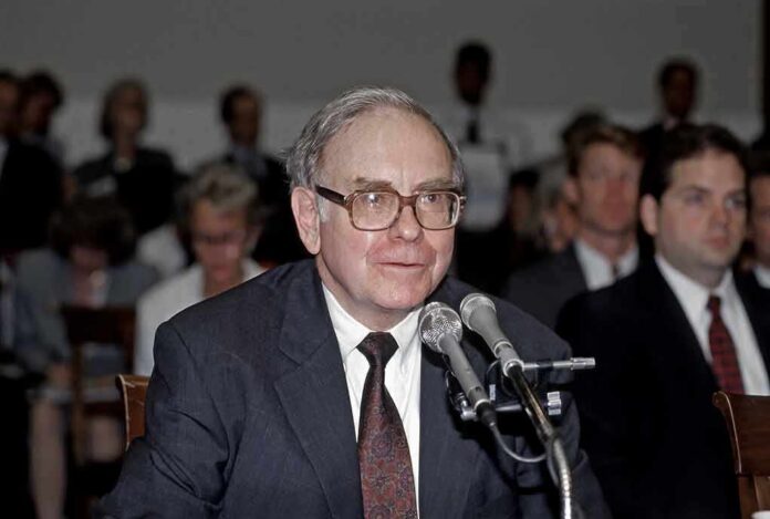 shutterstock_2177551623 Older man in suit speaking at microphones during hearing