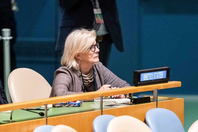 Woman seated at a United Nations desk with a United States nameplate