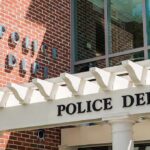 Police department entrance with pergola and brick wall