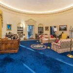 Oval Office interior with blue carpet and Resolute Desk