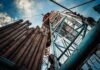 Oil drilling rig structure with stacked pipes viewed from below