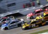 Stock cars racing side by side on a banked track