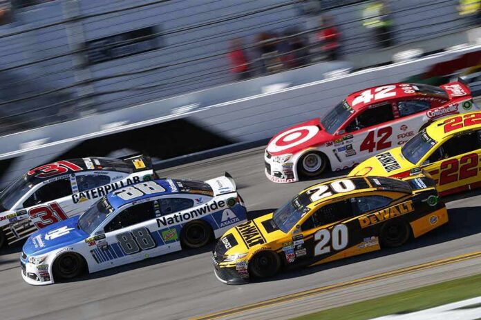 Stock cars racing side by side on a banked track