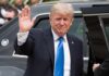 Trump NUKES Iran Deal – Strait Standoff Deepens Donald Trump waves while standing beside a black vehicle