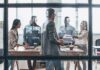 Team meeting in a modern office behind glass windows