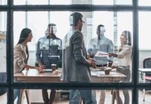 Team meeting in a modern office behind glass windows