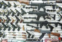 ICE Agents Targeted? Shocking Gun-Shop Rant Wall display of assorted firearms in a gun shop