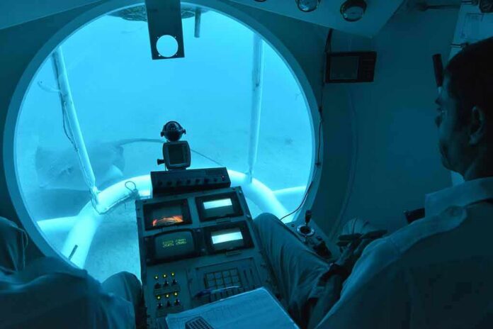 submarine interior with pilot viewing seafloor through large window