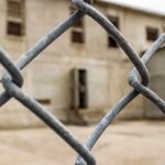 Chain-link fence with blurred concrete building behind