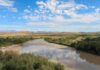 River winding through a desert valley under a blue sky