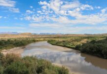River winding through a desert valley under a blue sky
