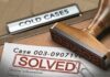 Rubber stamp marks solved on a case file